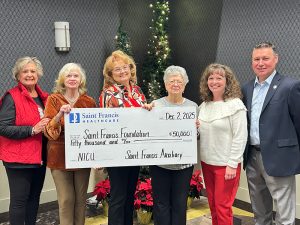 Auxilians Donate: Saint Francis Auxiliary Board members present check; Janet Esicar; BJ Bowman; Judi Owens; Betty Caroll; Teresa Hannah, Manager - Volunteer Services, and Stacy Huff, Saint Francis Foundation Executive Director.