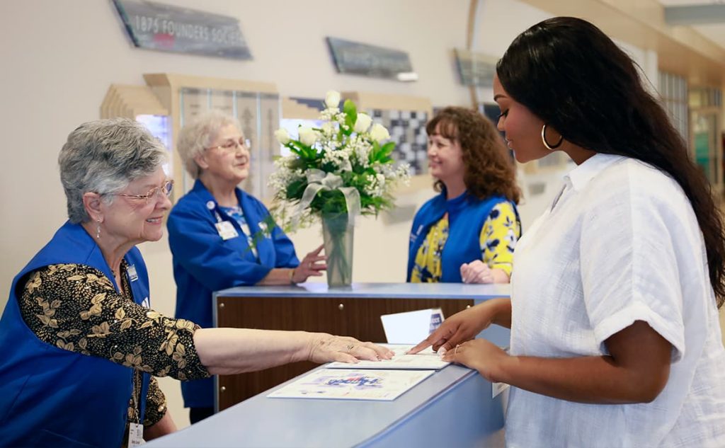 Volunteers greet at patient at Saint Francis Medical Center. Patient